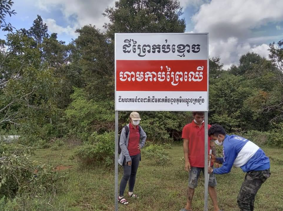 An indigenous group erects a sign to calling out the illegal grabbing of their collective land in Andong Kraloeng community