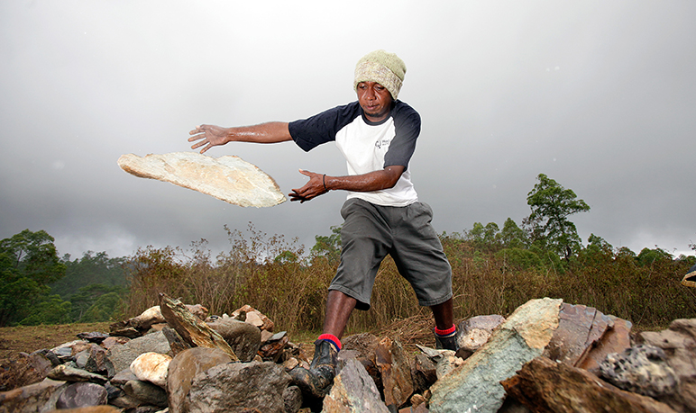 Domingus Asep Soares throws rocks into the cliff to build retention walls to assist with the erosion in Eraulo west of Dili. Asian Development Bank, 2011. CC BY-NC-SA 2.0